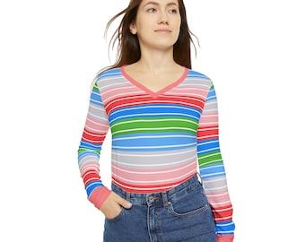 May include: A long-sleeved, V-neck shirt with horizontal stripes in red, pink, blue, green, and gray. The cuffs and neckline are a solid coral color. The shirt is paired with blue denim jeans.
