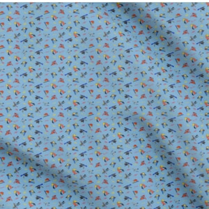 May include: Light blue fabric with a repeating pattern of colorful toucans, dragonflies, and small geometric shapes. The toucans are red, yellow, and black, while the dragonflies are blue and black. The fabric has a slightly wrinkled texture.