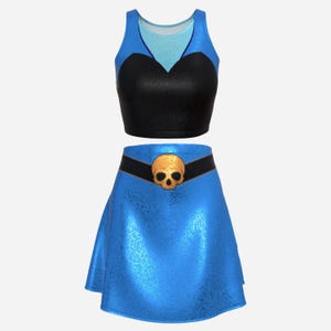 May include: A two-piece outfit featuring a blue and black crop top and a matching blue skirt. The top has a sweetheart neckline and the skirt has a black belt with a gold skull buckle. The outfit is likely made of a shiny material.