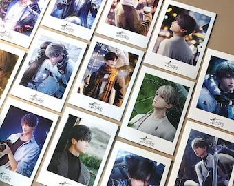 May include: A collection of polaroid-style prints featuring anime-style illustrations of a young man in various settings. The prints have a white border and include Chinese characters at the bottom. The illustrations showcase different outfits and poses.