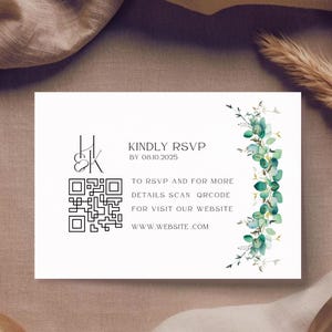 May include: White RSVP card with black text and a QR code. The card includes the text "KINDLY RSVP BY 08.10.2025" and "TO RSVP AND FOR MORE DETAILS SCAN QRCODE FOR VISIT OUR WEBSITE WWW.WEBSITE.COM". The card is decorated with green and gold floral elements.