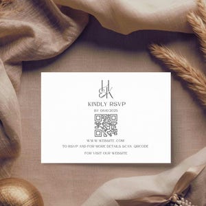 May include: A white invitation card with black text that reads "KINDLY RSVP" and "BY 08.10.2025". A QR code is below the text, with the website address and instructions to scan the code. The card is on a beige background.