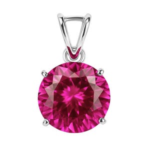 May include: A round, faceted, hot pink gemstone pendant with a silver bail. The gemstone is held in place by four silver prongs. A classic jewellery piece.