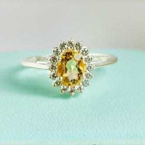 Citrine Ring: Sterling Silver Oval Gemstone with Zircon Halo