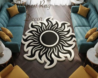 May include: A black and white sun-shaped rug is the focal point of a living room. The rug is surrounded by teal sofas, yellow chairs, and accent pillows. The room is decorated with lamps and small side tables.