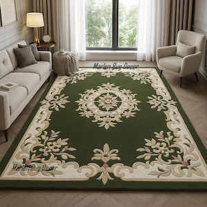 May include: A large, rectangular green rug with an ornate floral design. The rug features a central medallion and a border with cream and pink accents. The text "Marlen Rug Decor" is visible on the rug.