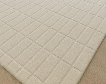 Tapete neutro creme, tufado à mão em lã, minimalista, texturizado, para sala de estar.