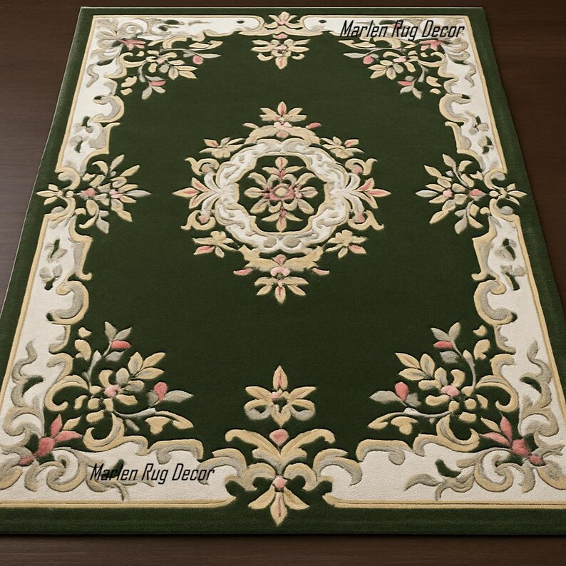 May include: A rectangular green rug with an ornate floral design. The rug features a central medallion and a border with cream, pink, and gold floral patterns. The text "Marlen Rug Decor" is visible in the corners.