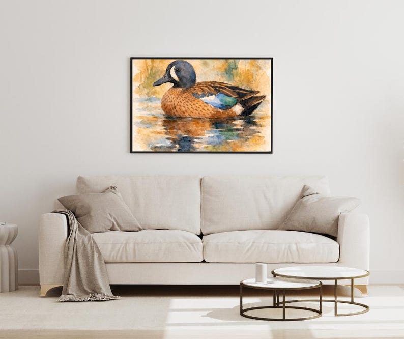 May include: A framed watercolor painting of a duck floating on water. The duck has a blue head, brown body, and blue and brown wings. The water reflects the duck and the surrounding colors of orange and green.