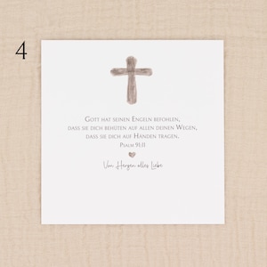 May include: A white card with a watercolor-style cross at the top. Below the cross is text in German, including Psalm 91:11. The card also includes the phrase "Von Herzen alles Liebe" and a small heart symbol.