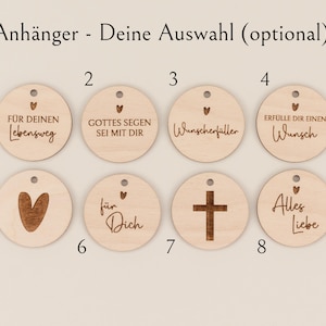 May include: A collection of eight wooden round pendants with various engraved designs and text. The pendants include a heart, a cross, and phrases like "For your journey" and "All love". Each pendant has a small hole at the top for hanging.
