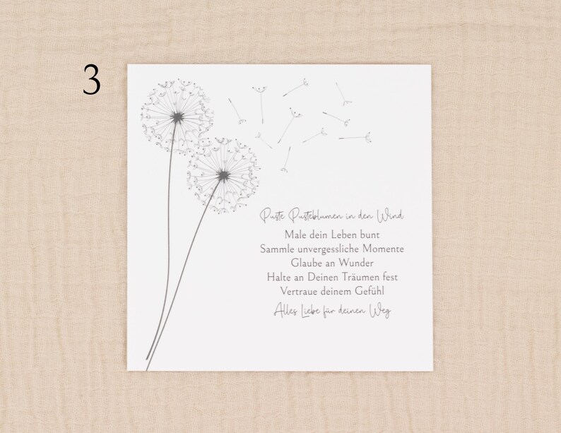 May include: A white square card with a dandelion illustration and German text. The dandelion design is in gray, with two full flower heads and several seeds floating away. The text is in a handwritten style.