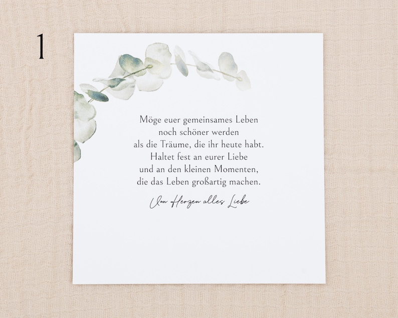 May include: A square white card featuring a watercolor illustration of green eucalyptus leaves along the top left corner. The card contains German text that reads: M&ouml;ge euer gemeinsames Leben noch sch&ouml;ner werden als die Tr&auml;ume, die ihr heute habt.