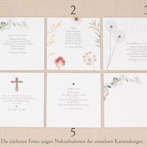 May include: A collection of six white cards with various designs. Some cards feature floral arrangements, while others have text in German. One card displays a cross, and another has a heart symbol. The cards are arranged on a light beige surface.