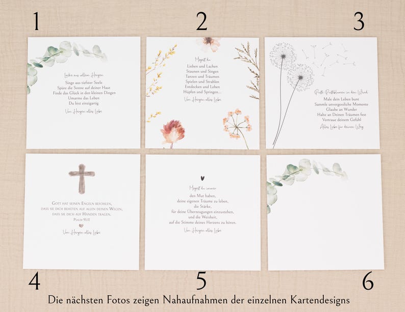 May include: Six white cards with different designs are shown. Some cards have floral arrangements, and others have German text. One card features a cross, and another has a heart symbol. The cards are displayed on a light beige surface.