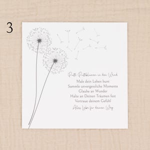 May include: A white square card featuring a dandelion illustration and German text. The dandelion design is in grey, with two full flower heads and several seeds floating away. The text is in a handwritten style.