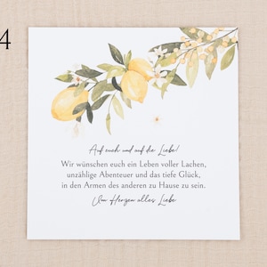 May include: A square greeting card featuring a watercolor illustration of yellow lemons, green leaves, and small white flowers at the top. The text reads: Auf euch und auf die Liebe! Wir w&uuml;nschen euch ein Leben voller Lachen, unz&auml;hlige Abenteuer und das tiefe Gl&uuml;ck, in den Armen des anderen zu Hause zu sein. Im Herzen alles Liebe.