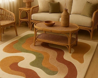 May include: A living room with a cream rug featuring an abstract design in orange, green, and brown. The room includes rattan furniture, a beige sofa with green and beige cushions, and a wooden coffee table. A vase with dried plants sits on the table.