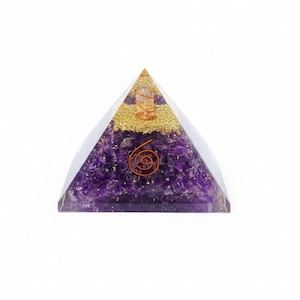 May include: An orgone energy pyramid with a clear resin exterior. It contains amethyst crystals, gold flakes, and a copper coil. A clear quartz crystal sits at the apex. The pyramid is approximately 7 cm tall.