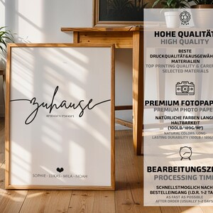 May include: A framed print with the word "zuhause" in elegant script, coordinates, and names. The print is in a wooden frame and is displayed on a wooden surface. The image also includes text about high quality and processing time.