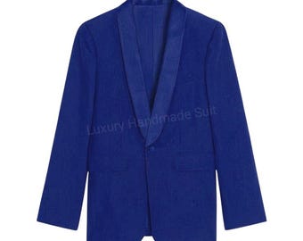 May include: A vibrant blue blazer with a shawl collar and two front pockets. The jacket has a single-button closure and the text "Luxury Handmade Suit" is visible. This tailored garment is suitable for formal occasions.