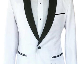 May include: A white tuxedo jacket with black lapels, a black bow tie, and a white dress shirt. The jacket has a single-button closure and black trim on the pockets. The text "Luxury Handmade Suit" is visible on the jacket.