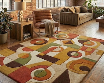 May include: A geometric patterned area rug with a mix of shapes and colors, including orange, green, yellow, and brown. The rug is rectangular and placed on a hardwood floor, adding a touch of modern design to the room.