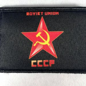 May include: Black rectangular patch featuring a red star with a yellow hammer and sickle emblem. The words "SOVIET UNION" and "CCCP" are printed in red. The patch has a black border.