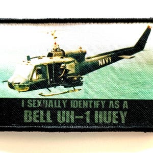 Peut inclure: Écusson rectangulaire représentant un hélicoptère militaire avec le mot "NAVY" sur le côté. Le patch contient le texte "I SEXUALLY IDENTIFY AS A BELL UH-1 HUEY" en vert sur fond noir.