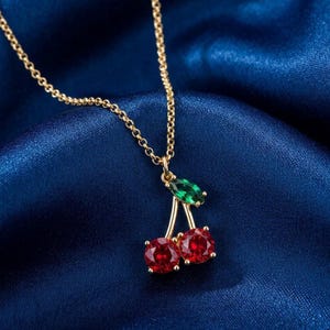 May include: A white ceramic mug with a black handle and the text "But First, Coffee" in a bold, black font. The mug is filled with a dark liquid, likely coffee, and sits on a light-colored surface.