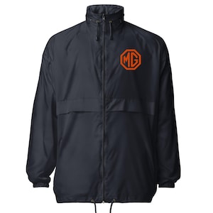 May include: Navy blue windbreaker jacket with a full zipper and a high collar. The jacket features an orange MG logo on the left chest. The jacket has a drawstring at the bottom and a hood.