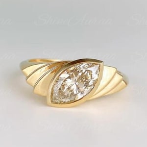 May include: A set of three ceramic mugs with a speckled, matte finish. The mugs are in shades of cream, light gray, and dark gray. Each mug has a simple, modern design and a rounded handle. The mugs are suitable for coffee, tea, or other beverages.