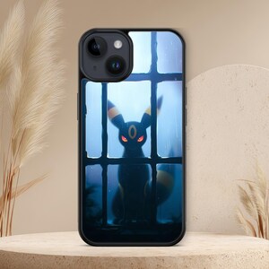 May include: A black smartphone case featuring a graphic illustration of a dark, fox-like creature with glowing red eyes and yellow ring markings, positioned behind a window pane with a blue, rainy, and atmospheric background.
