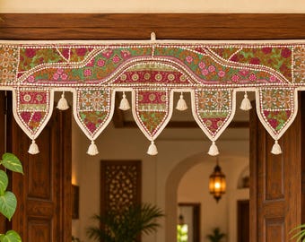 May include: A rectangular fabric door valance featuring intricate embroidery in shades of magenta, green, and white. The valance has five pointed, downward-hanging panels, each finished with a small white tassel at the bottom point.