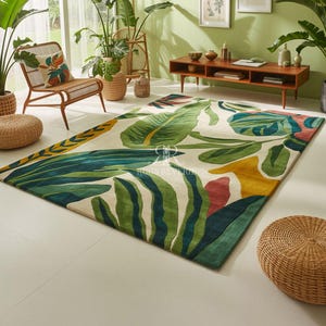 May include: A large rectangular rug with a tropical leaf design in shades of green, yellow, and red on a cream background. The rug is placed in a room with plants and natural light.