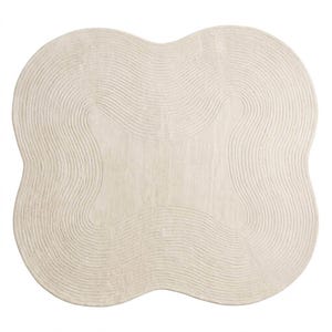 May include: An off-white area rug with a distinct four-lobed, clover-like shape. The surface features a series of concentric, raised line patterns that follow the curved contours of the rug, creating a textured, ripple-like effect across the entire piece.