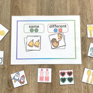 May include: Educational game with cards featuring images of objects and the words "same" and "different." Includes images of bells, clocks, rockets, bottles, sunglasses, keys, seahorses, shells, and utensils.