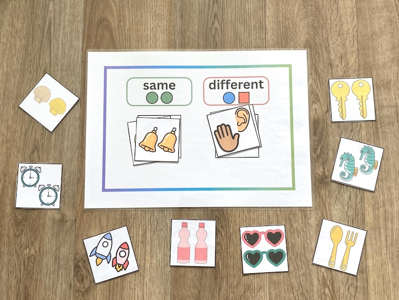 May include: Educational game with cards featuring images of objects and the words "same" and "different." Includes images of bells, clocks, rockets, bottles, sunglasses, keys, seahorses, shells, and utensils.
