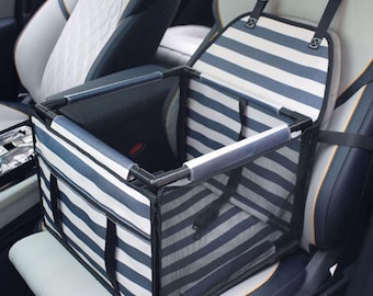 May include: A blue and white striped pet car seat carrier. The carrier is rectangular with a mesh front and sides, and a black frame. It has straps to secure it to the car seat and a handle. The carrier is designed to keep pets safe and secure while traveling.