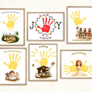 May include: A collection of six framed art prints with a Christmas theme. Each print features a yellow handprint design, accompanied by illustrations of nativity scenes, angels, and the text "Oh Little Town of Bethlehem", "Unto Us A Saviour Is Born", and "Joy".