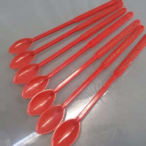 May include: Six red plastic spoons with the text "Famous Oriental Restaurant" printed on them.