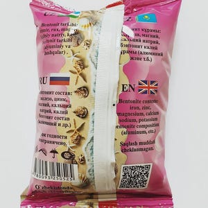 May include: A pink and white package with text in multiple languages, including English and Russian. The package lists ingredients such as iron, zinc, and magnesium. The design includes images of seashells.