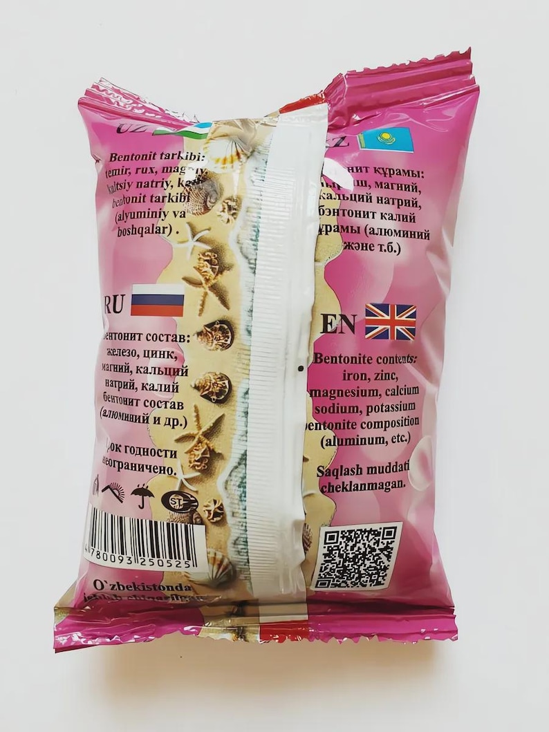 May include: A pink and white package with text in multiple languages, including English and Russian. The package lists ingredients such as iron, zinc, and magnesium. The design includes images of seashells.