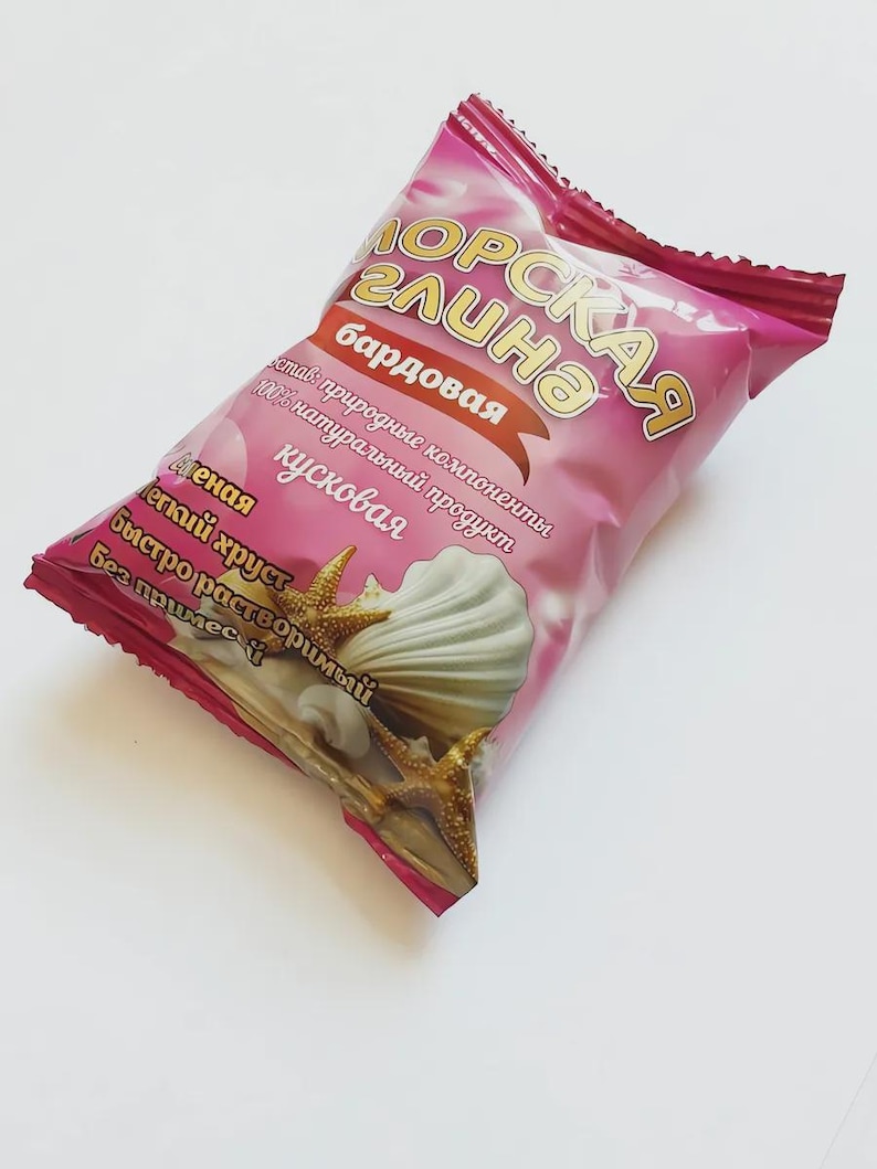 May include: A pink package of "Morskaya Glina" candy, featuring a seashell and starfish design. The package has Russian text, including "natural ingredients" and "easily soluble."