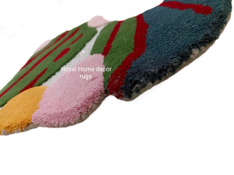 May include: Abstract rug with a textured surface. The rug features a colorful design with sections of green, red, pink, yellow, and blue. The text "Royal Home decor rugs" is visible on the rug.
