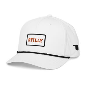 May include: White baseball cap with a black rope detail and a curved brim. The cap features the word "STILLY" in orange letters inside a black rectangle on the front. A black outline of Oklahoma is on the side.