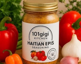May include: A glass jar of Haitian Epis seasoning with a gold lid and a white label. The label features the text "101gigi Kitchen" and "Haitian Epis Seasoning." Red bell peppers, an orange pepper, garlic, and an onion are in the background.