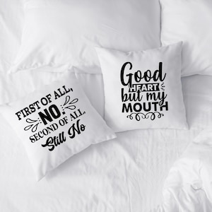 May include: Two white throw pillows with black text. One pillow reads "FIRST OF ALL, NO, SECOND OF ALL, Still No." The other pillow says "Good HEART but my MOUTH."