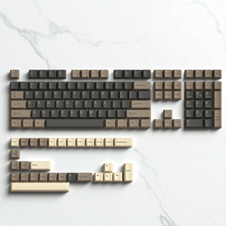 May include: A disassembled mechanical keyboard with keycaps in shades of brown, beige, and black, arranged on a white marble surface. The keycaps are organized to show the layout of the keyboard, including the main keys, number pad, and function keys.