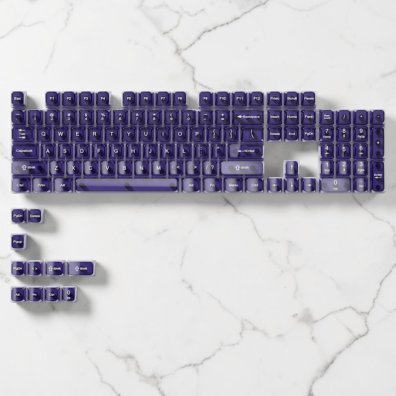 May include: A mechanical keyboard with purple keycaps, displayed in a disassembled state. The keycaps are laid out on a white marble surface, revealing the keyboard's structure. The keycaps are purple with white lettering.